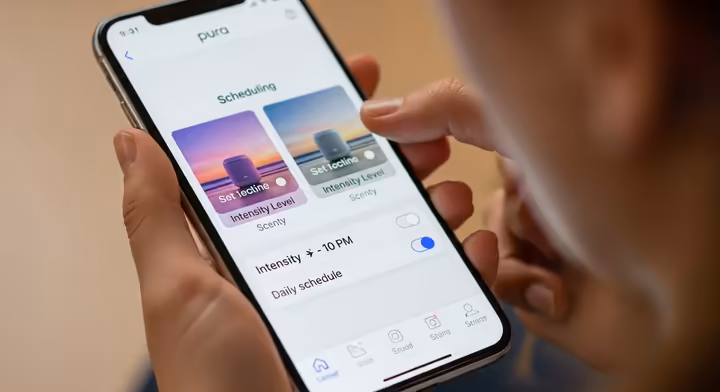 A smartphone screen showing the Pura app interface, with a user setting a custom schedule and intensity for their diffuser.
